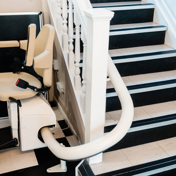 White Stairlift On Staircase For Disabled People And Elderly Peo